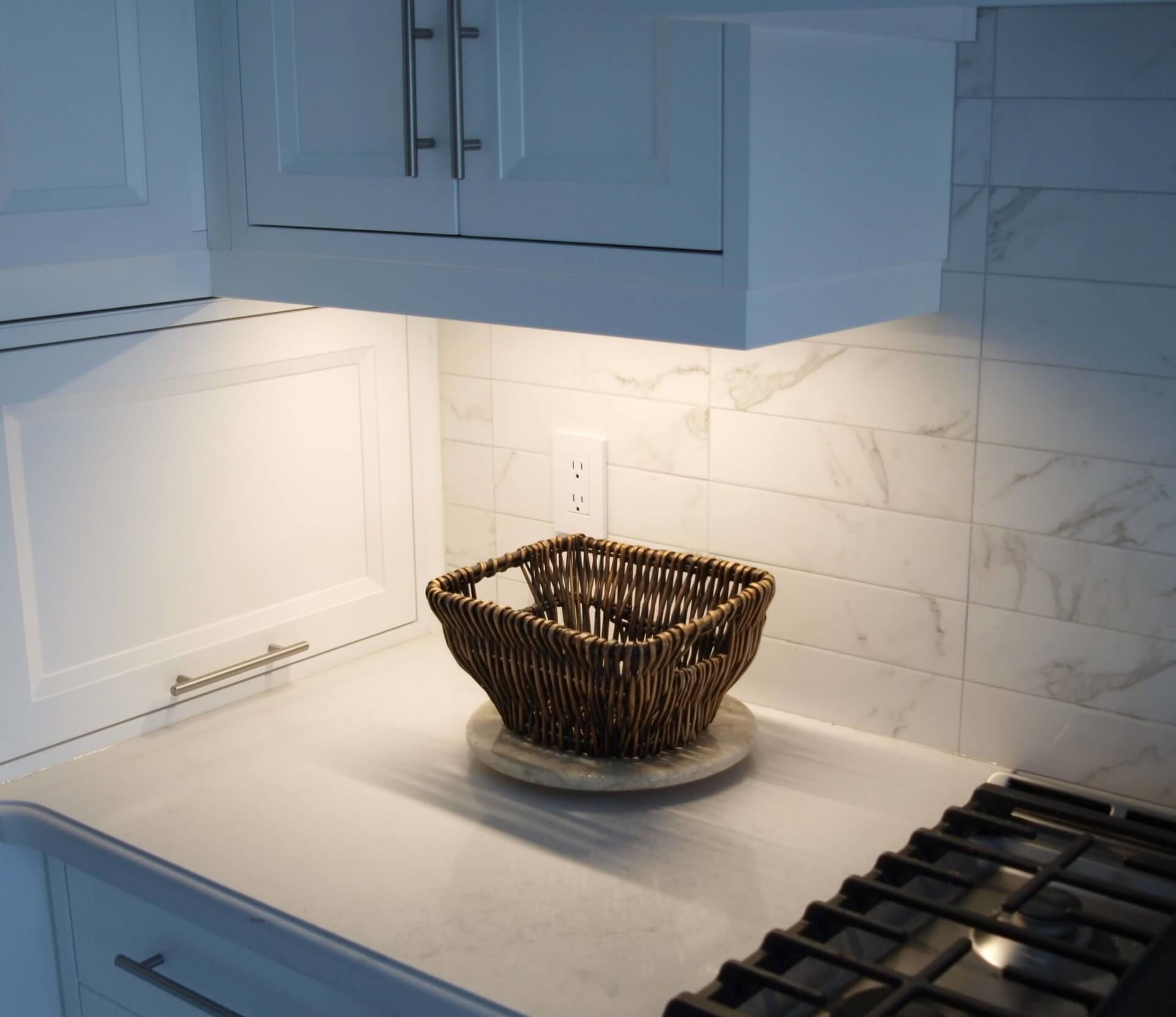 Illuminated kitchen backsplash with under-cabinet LED lighting