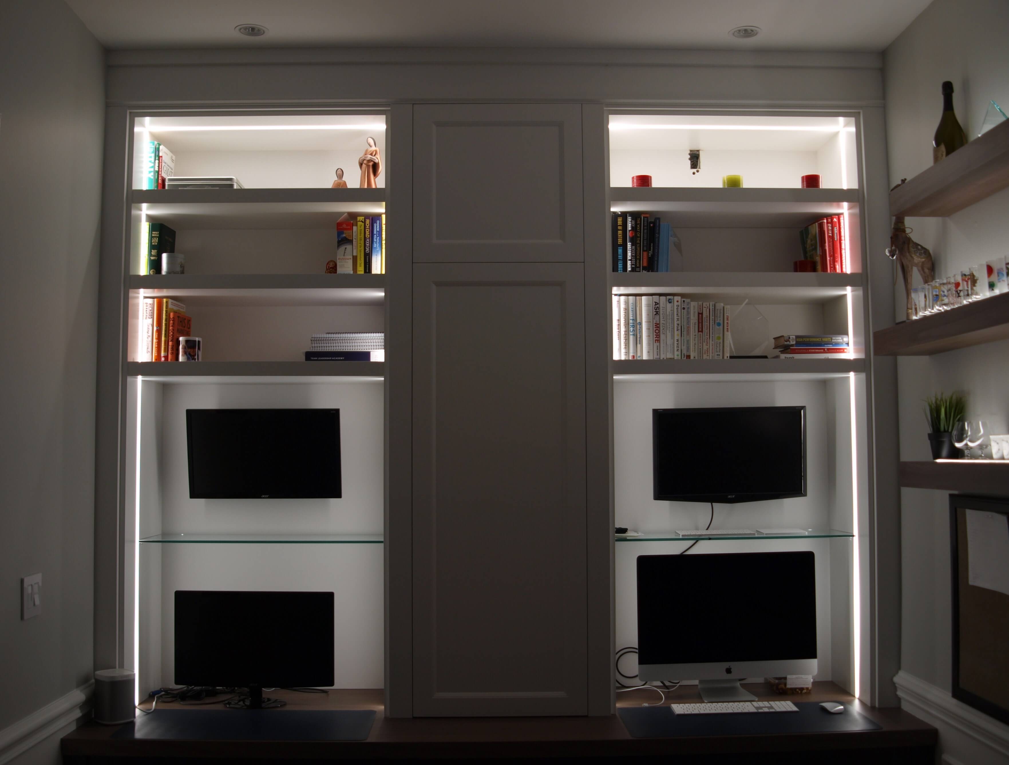Custom linear LED shelf lighting integrated into home office millwork